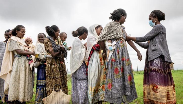 Mothers and children outside a health post in Hibret village, Tigray region, being screened for malnutrition